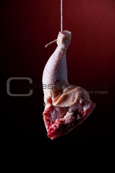 hanging chicken leg on red