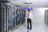businessman hold umbrella in server room