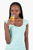 Young woman drinking some orange juice