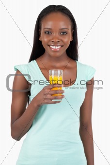 Happy smiling woman with a glass of orange juice