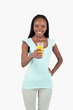 Happy smiling female holding a glass of orange juice