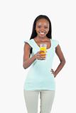 Smiling young female having a glass of orange juice