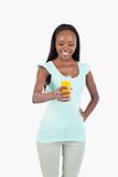 Smiling young woman holding a glass of orange juice