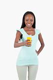 Glass of orange juice being held by smiling young woman
