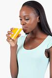 Side view of young woman drinking orange juice