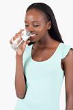 Young woman looking into her glass of water