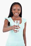 Happy smiling woman offering a glass of water