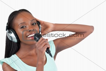 Woman with headphones on singing
