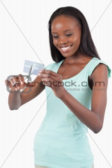 Smiling woman cutting her credit card into pieces