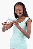 Smiling young woman destroying her credit card
