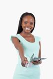 Smiling young woman paying with her credit card