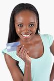 Smiling young woman showing her credit card