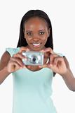 Smiling young woman using her digital camera