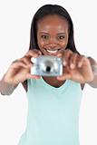 Smiling young woman taking a picture