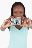 Camera used for taking photos by smiling young woman