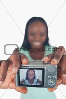 Young woman taking photo of herself
