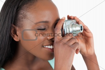 Side view of young woman taking a picture
