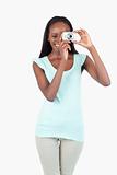 Smiling young woman taking pictures