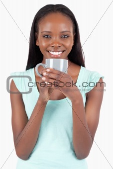 Smiling young woman with a cup of coffee