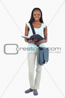 Smiling young student with her book