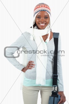 Young student in winter clothes and hand on her hip