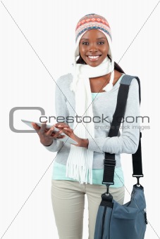 Young woman in winter clothes using tablet
