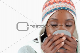 Young woman enjoying a cup of tea in the cold