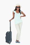 Smiling young woman with suitcase
