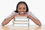 Student with her chin on a stack a book
