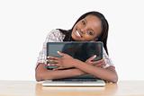 Young woman hugging her laptop