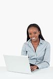 Portrait of a smiling businesswoman using a laptop
