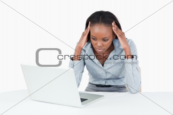 Tired businesswoman working with a laptop