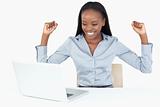Joyful businesswoman working with a laptop