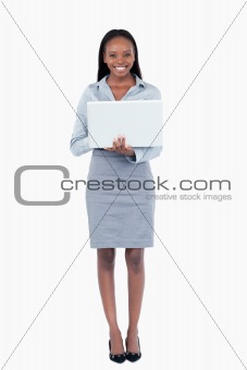 Portrait of a businesswoman using a laptop while standing up
