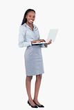 Portrait of a happy businesswoman using a laptop while standing up