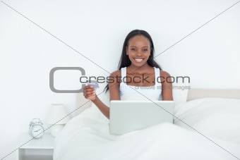 Smiling woman booking her holidays online