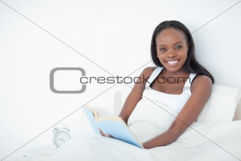 Happy woman holding a book