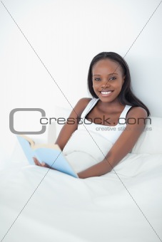 Portrait of a happy woman holding a book