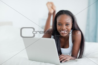 Woman lying on her belly with a laptop