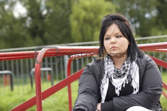 Young Woman Sitting In Playground
