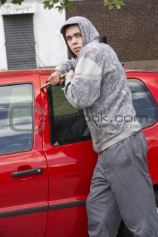 Young Man Breaking Into Car