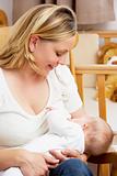 Mother Breastfeeding Baby In Nursery