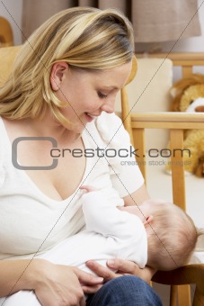Mother Breastfeeding Baby In Nursery