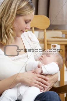 Mother Holding Baby In Nursery