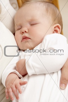 Mother Holding Sleeping Baby In Nursery