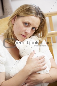 Sad Mother Sitting In Empty Nursery