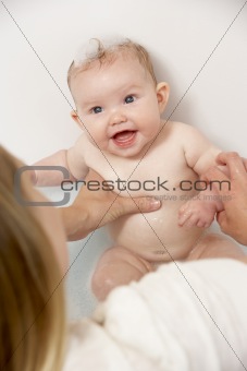 Mother Bathing Baby At Home
