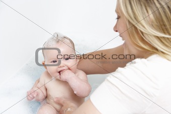Mother Bathing Baby At Home