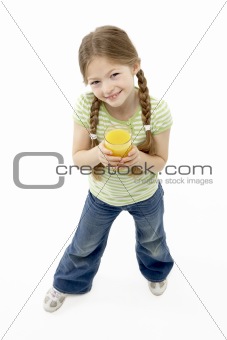 Studio Portrait of Smiling Girl Holding Orange Juice
