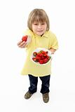 Studio Portrait of Smiling Boy Holding Bowl of Strawberries